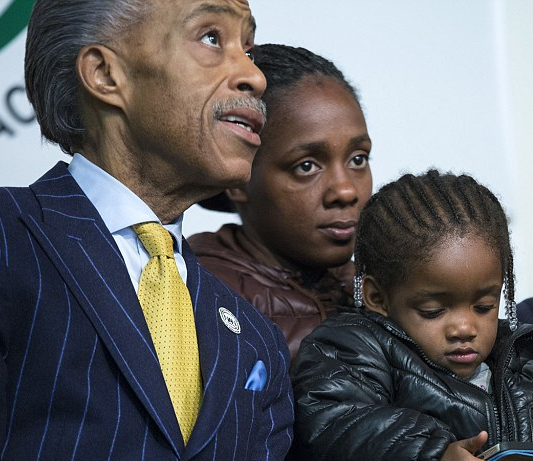 Al Sharpton with Mr. Gurley's 2-year-old daughter Akaila and the mother, Kimberly Ballinger. AP Photo.